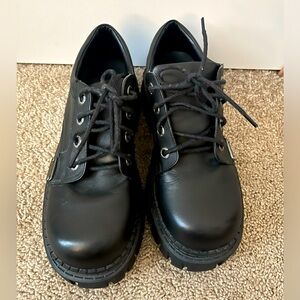 Chunky low top black Unif shoes.